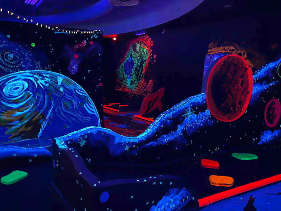 Space mural with red moon and glowing cave entrance at Gilbert
