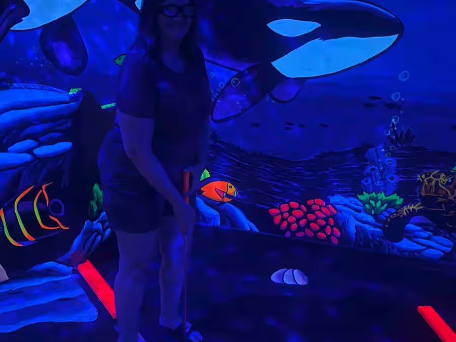 Close-up glowing cave entrance mural at Imagine 3D Mini Golf Gilbert
