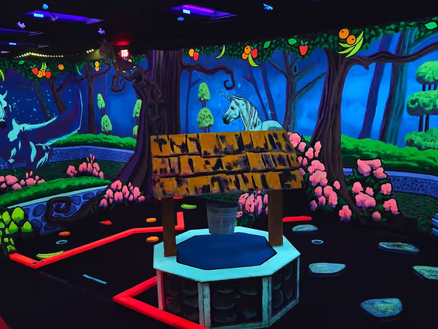 Unicorn and wishing well fantasy forest hole at Imagine 3D Mini Golf Gilbert