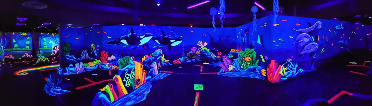 Panoramic view of the underwater world with orca whale mural and coral reef fairways at Imagine 3D Mini Golf