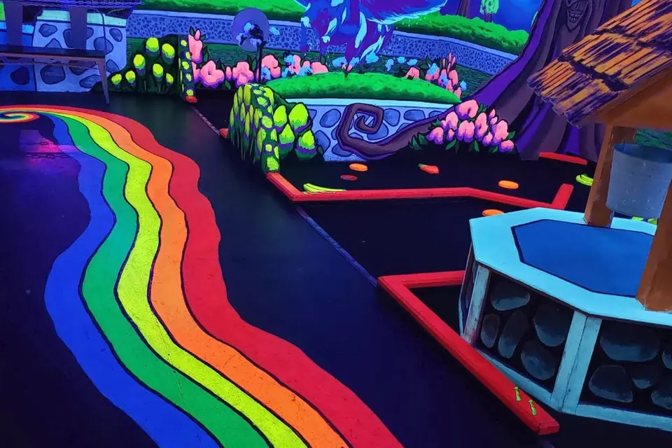 Player navigating a glowing 3D mini golf hole in Gilbert AZ
