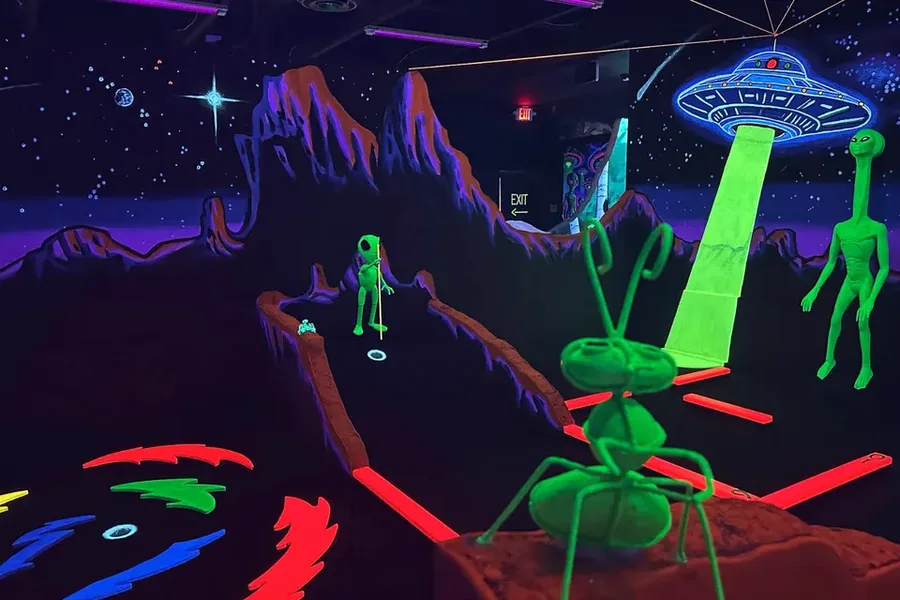 Glowing blacklight alien mural on the 3D mini golf course