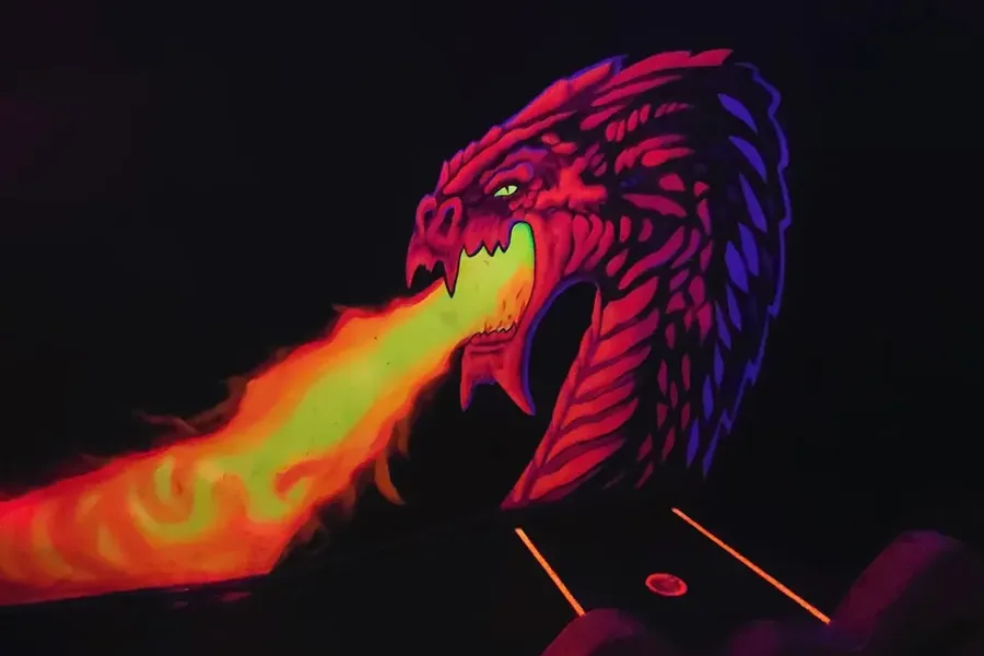 Glowing blacklight dragon cave mural on the 3D mini golf course