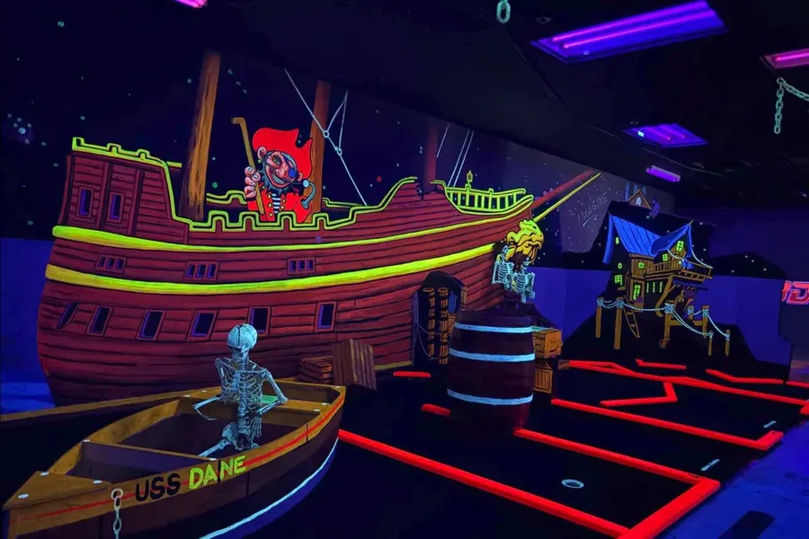 Glowing blacklight pirate ship room on the 3D mini golf course