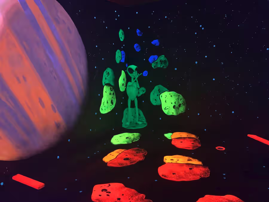 Planet and meteor field mural with alien figure at Scottsdale