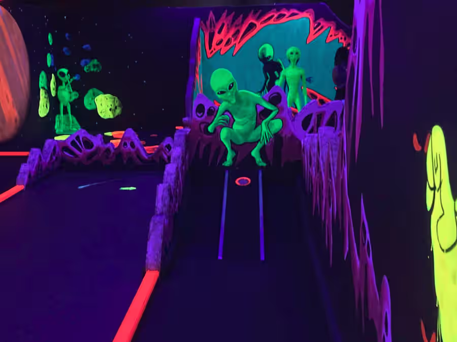 Glowing monster mural with alien crew on the Scottsdale course