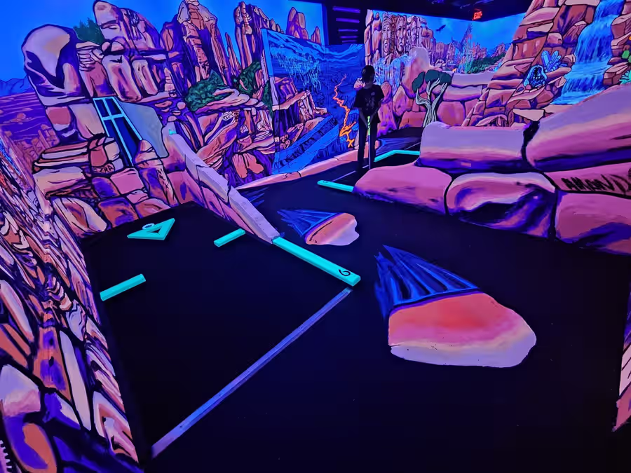 Blacklight red rock canyon mural on the Sedona course