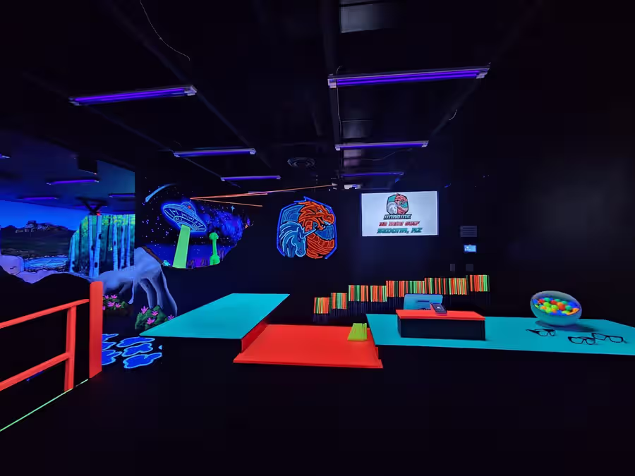 Sedona front desk with glowing UFO mural and logo