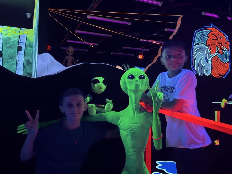 Kids posing with glowing alien statues at Sedona
