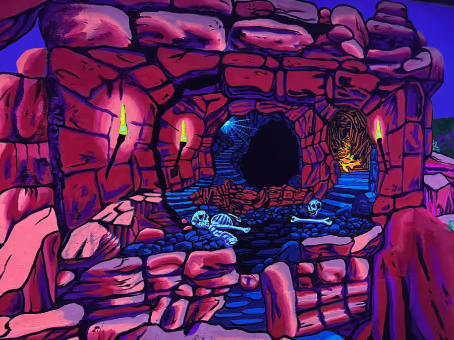 Torch-lit stone tunnel with skeleton remains at Sedona
